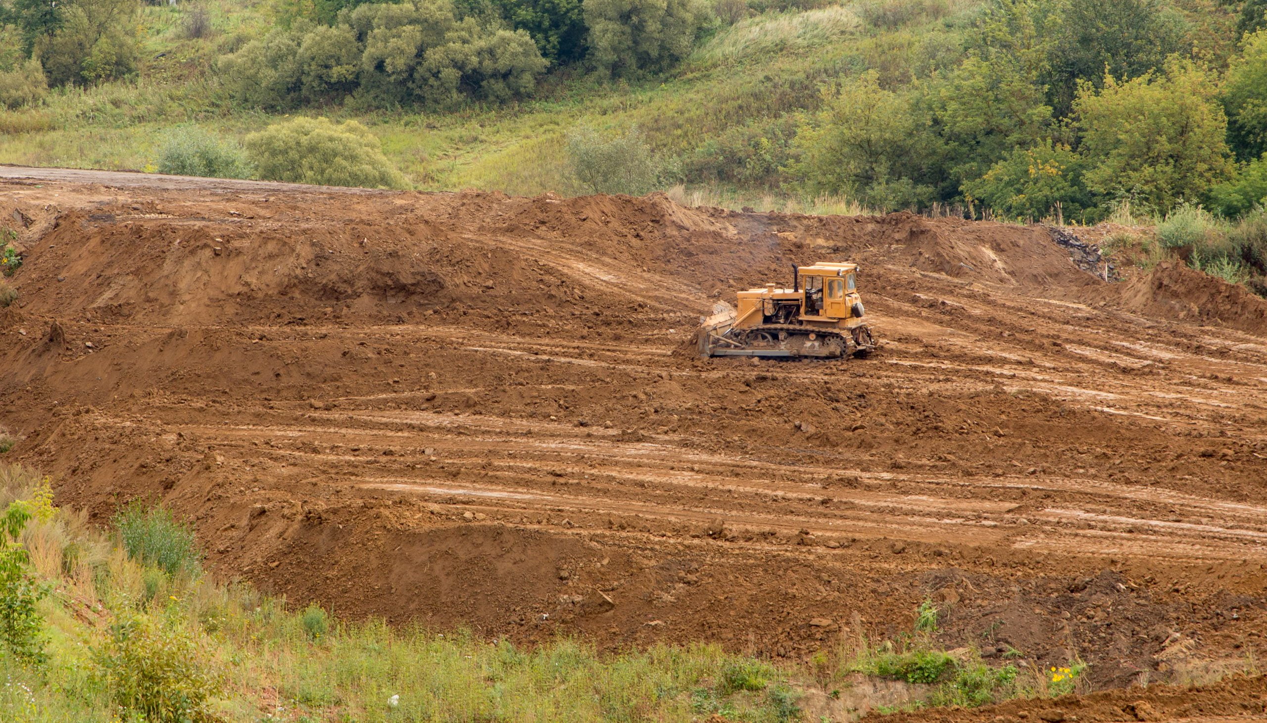 a bulldozer on a dirt hill